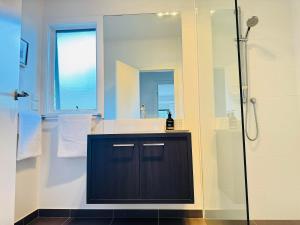 a bathroom with a shower and a sink and a mirror at RYE HOLIDAY AWAY in Rye