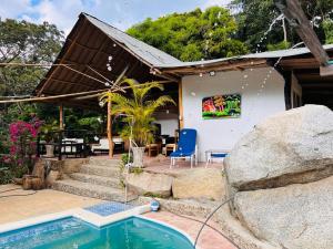 a house with a swimming pool in front of it at Cabaña Minca sierra nevada in Santa Marta