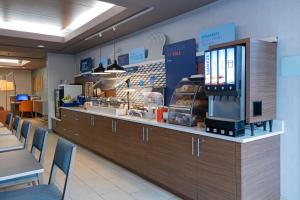 a fast food restaurant with a counter and chairs at Holiday Inn Express Kamloops, an IHG Hotel in Kamloops