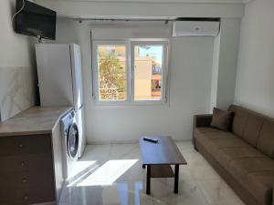a living room with a couch and a refrigerator at City Stay Kavala in Kavala