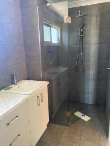 a bathroom with a shower and a sink at Corowa Bindaree Holiday Park in Corowa