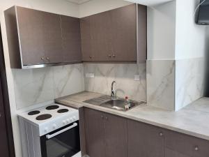 a kitchen with a sink and a stove at City Stay Kavala in Kavala