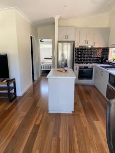 a kitchen with white cabinets and a white counter top at Corowa Bindaree Holiday Park in Corowa