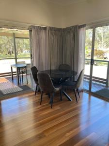 a dining room with a black table and chairs at Corowa Bindaree Holiday Park in Corowa