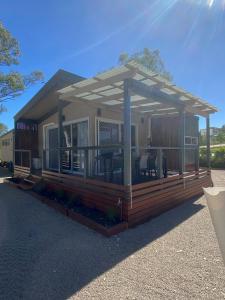 a screened in porch on a house with a deck at Corowa Bindaree Holiday Park in Corowa
