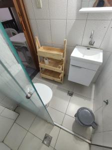 a small bathroom with a toilet and a sink at Residência RCA13 in Santos