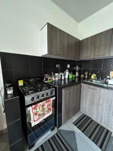 a kitchen with a stove and a sink at Amiri in Puerto Colombia