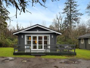 a tiny house with a porch and a window at Leven Lodge 2 - Uk46044 in Balloch