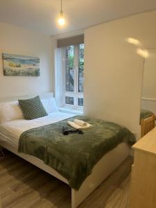 a bedroom with a bed and a window at Lovely Double Rooms in Euston & Square in London
