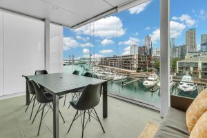 a dining room with a view of a marina at QV Apartment Overlooking the Viaduct (1137) in Auckland