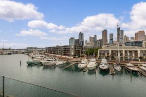 a group of boats docked in a harbor with a city at QV Apartment Overlooking the Viaduct (1137) in Auckland