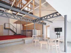 a room with tables and chairs and a stage at 別邸 仲乃家 in Tochigi +11 photos