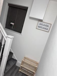 a white staircase with a window and a sign at Flat in Leicester! in Leicester