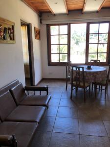 a living room with a couch and a table at La Posada Encantada in Mar del Plata +32 photos