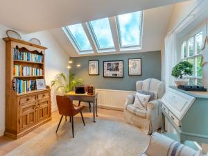 a living room with a skylight and a desk and chair at The Cottage in Hungerton