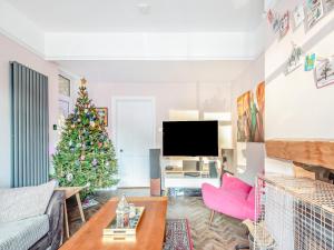 a living room with a christmas tree and a couch at Clumber Lodge in Retford