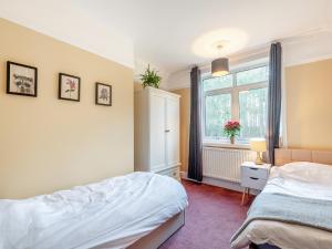 a bedroom with a bed and a window at Clumber Lodge in Retford