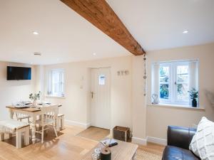 a living room with a table and a couch at Northwood Farm Cottage in Marchamley