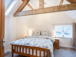 a bedroom with a bed and a window at Northwood Farm Cottage in Marchamley