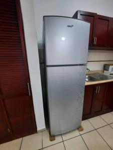 a white refrigerator freezer sitting in a kitchen at Centro histórico, tranquilo y con terraza in Querétaro
