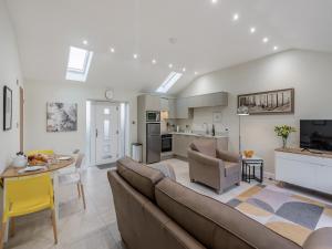 a living room with a couch and a table at Mabels Stable in Clitheroe