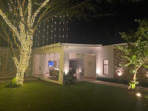 a house with lights on the front of it at night at La Escondida Samber in San Bernardino