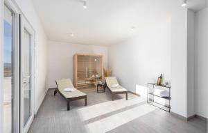 a white room with two chairs and a table at Gorgeous Home In Trilj With Sauna in Trilj