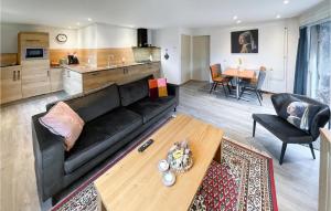 a living room with a black couch and a table at Waddenzee in Moddergat