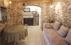 a kitchen with a table and a couch in a room at Cozy Home In Donje Selo With Kitchen in Donje Selo na Šolti