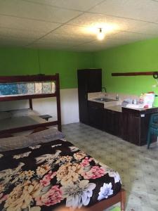a room with bunk beds and a kitchen with a sink at Hostal Camping Beach in Salinas