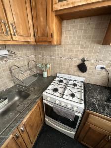 a kitchen with a stove and a sink at CorrientesNice in Buenos Aires