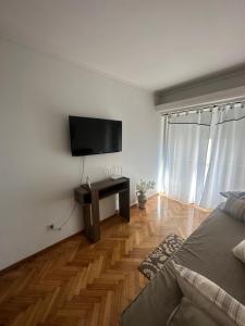 a bedroom with a flat screen tv on a wall at CorrientesNice in Buenos Aires