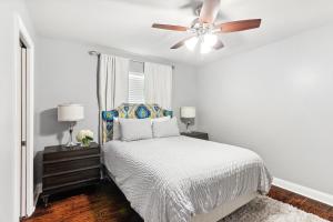 a bedroom with a bed and a ceiling fan at Amazing 3bedroom townhome, in Historic Dryade City in New Orleans