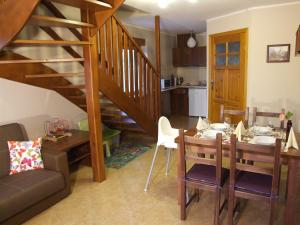 a living room with a dining room table and a staircase at Banskie Zacisze in Szaflary