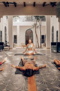 a group of people laying on the floor in a yoga class at Yum Kaax Boutique Villa in Tulum
