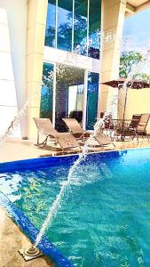 a swimming pool with a fountain in a building at Casa el Recuerdo in Villavicencio