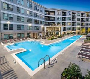 a large swimming pool in front of a building at Upscale Luxury Fully loaded Equipped Loft in Atlanta