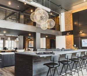a kitchen with a large counter with bar stools at Upscale Luxury Fully loaded Equipped Loft in Atlanta