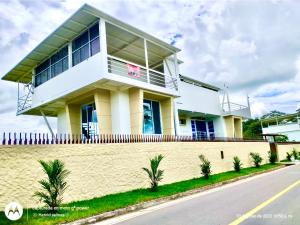 a white house on the side of a road at Casa el Recuerdo in Villavicencio