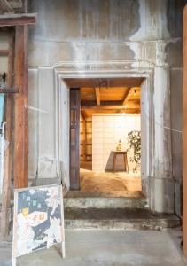 an entrance to a building with a sign in the doorway at 囲炉裏町家Guesthouse FUJITA 一棟貸切 villa 無料駐車場 in Hakusan