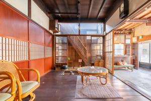 a room with a table and chairs and a staircase at 囲炉裏町家Guesthouse FUJITA 一棟貸切 villa 無料駐車場 in Hakusan