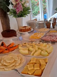 una mesa con muchos platos de comida. en Hotel Liberdade Búzios, en Búzios