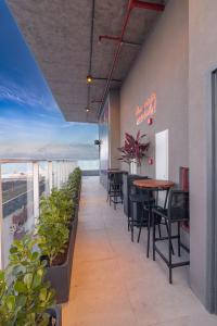 een restaurant met tafels en stoelen op een balkon bij Place2You Hotel by Welkom in João Pessoa