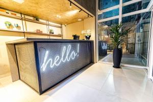 a large tv in a store with a hello sign on it at Place2You Hotel by Welkom in João Pessoa