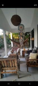 a living room with benches and a chandelier at Ponta negra garden in Natal