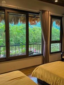 a bedroom with two beds and a window with a view at Halise Home and Retreat Ninh Binh in Ninh Binh +71 photos