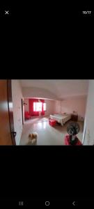 a room with a dog running around in a room at Ponta negra garden in Natal