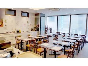 a room with tables and chairs in a restaurant at Sun Royal Kawasaki - Vacation STAY 98721v in Kawasaki
