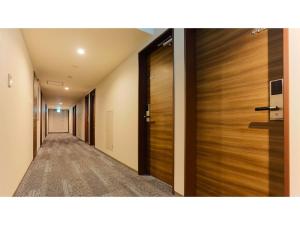 a corridor of a hotel with wooden doors at Sun Royal Kawasaki - Vacation STAY 98721v in Kawasaki