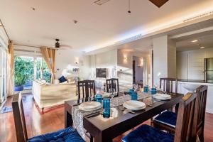 a dining room and living room with a table and chairs at 3BR Family Home in Laguna — 100m walk from beach in Phuket Town